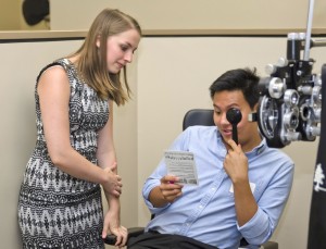 Lauren Bruehl, a UW-Madison alumnus, performing a refraction at the Southern College of Optometry.